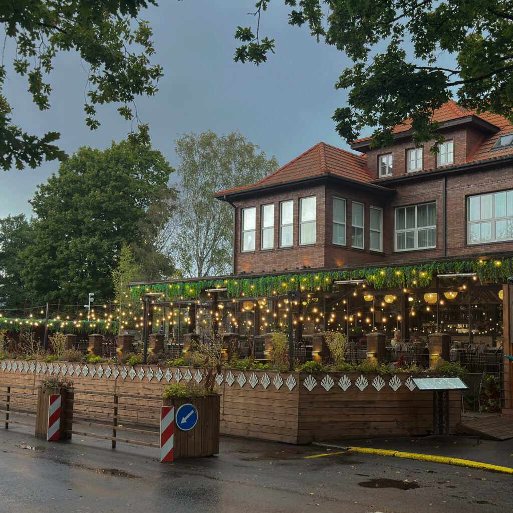 Võluv restoran tulede ja puidust aiaga.