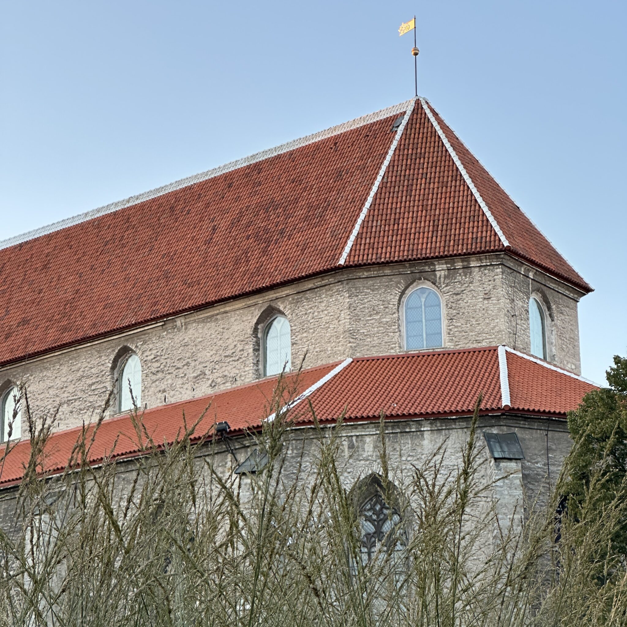 Ajalooline kirik punase katuse ja tipul lehviva lipuga.