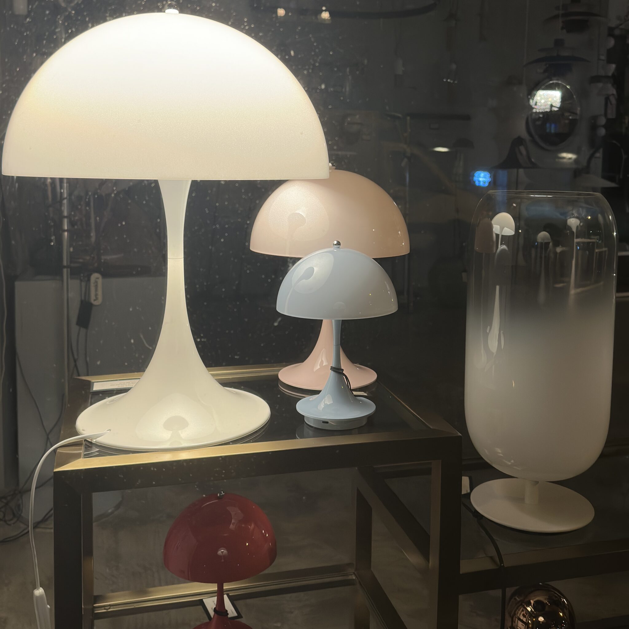 Kolm seenekujulise varjuga laualampi väljapanekul.