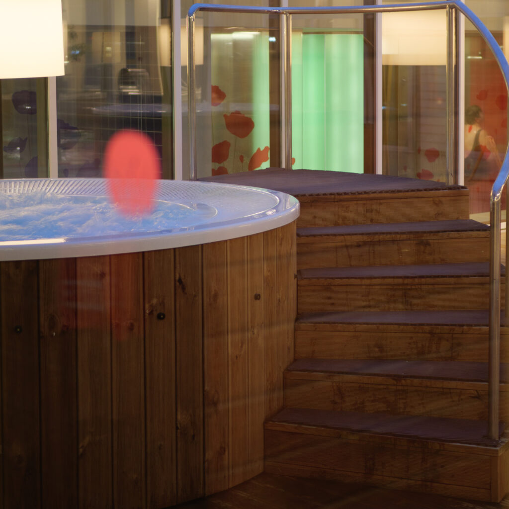 Moodne mullivann puidust detailide ja klaaspiirdega.