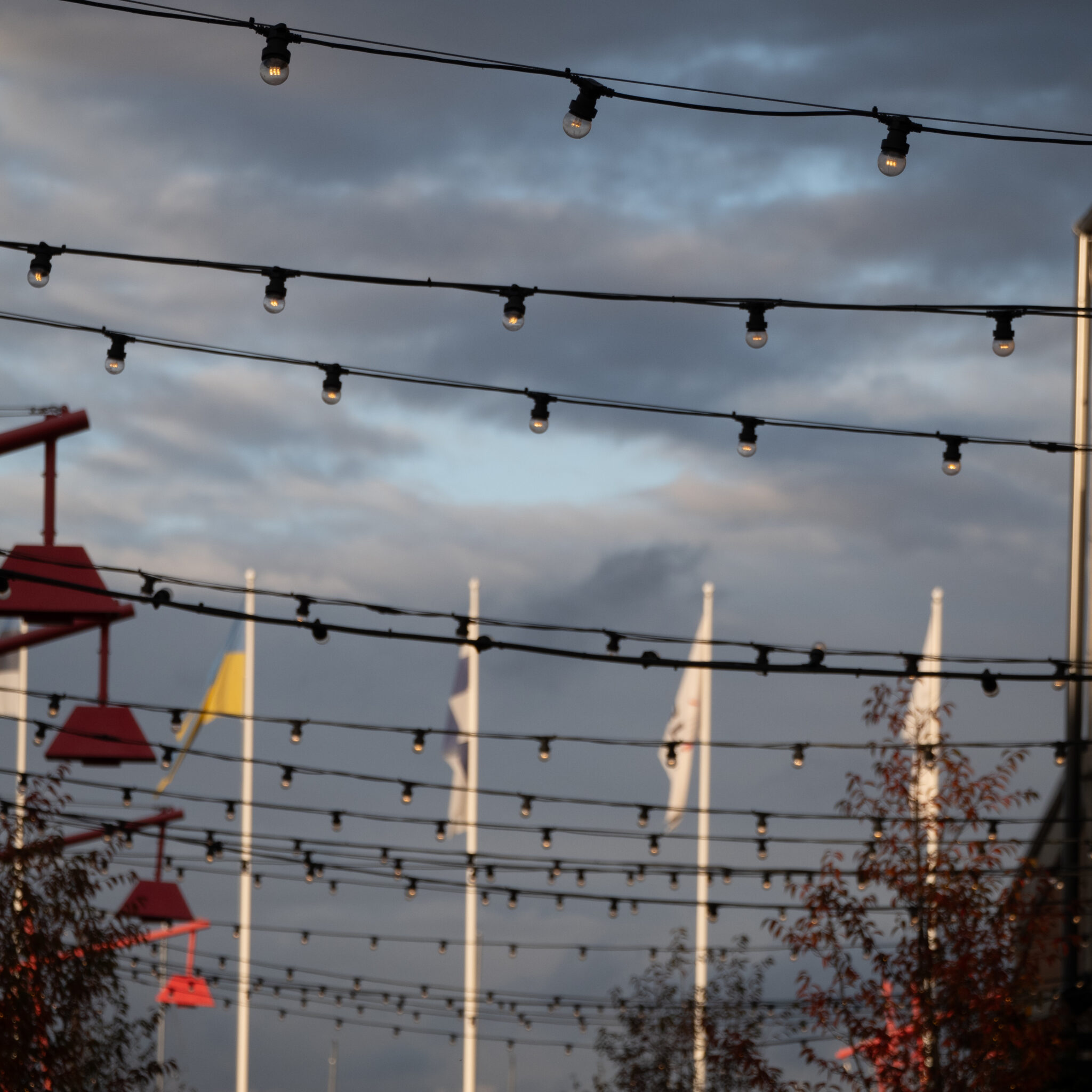 Valgustid ja lipud pilvise taeva taustal.