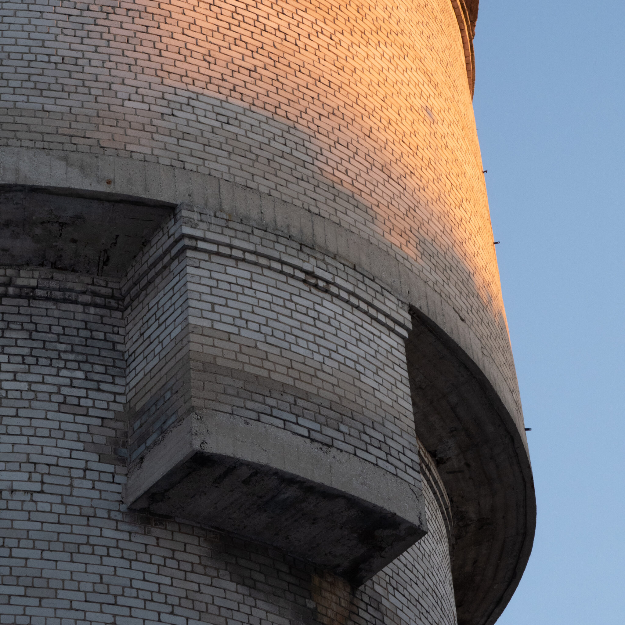 Kumera fassaadi ja rõdudega tellistorn selge taeva taustal.